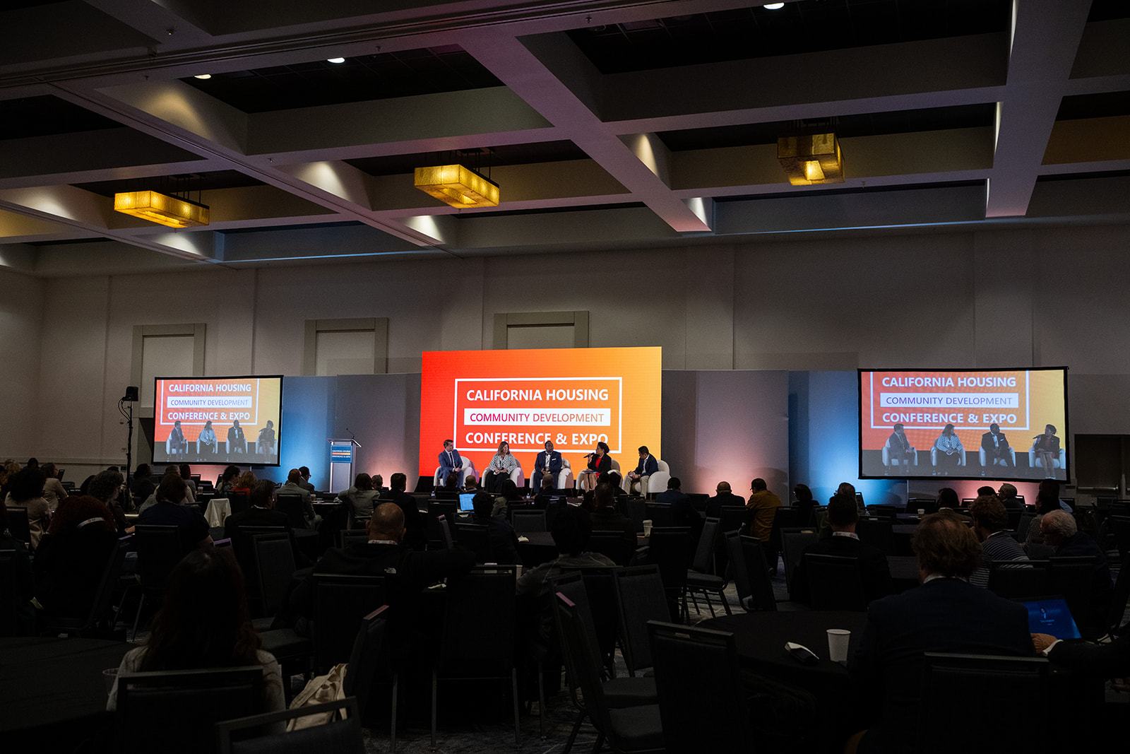 A full ballroom facing the main stage