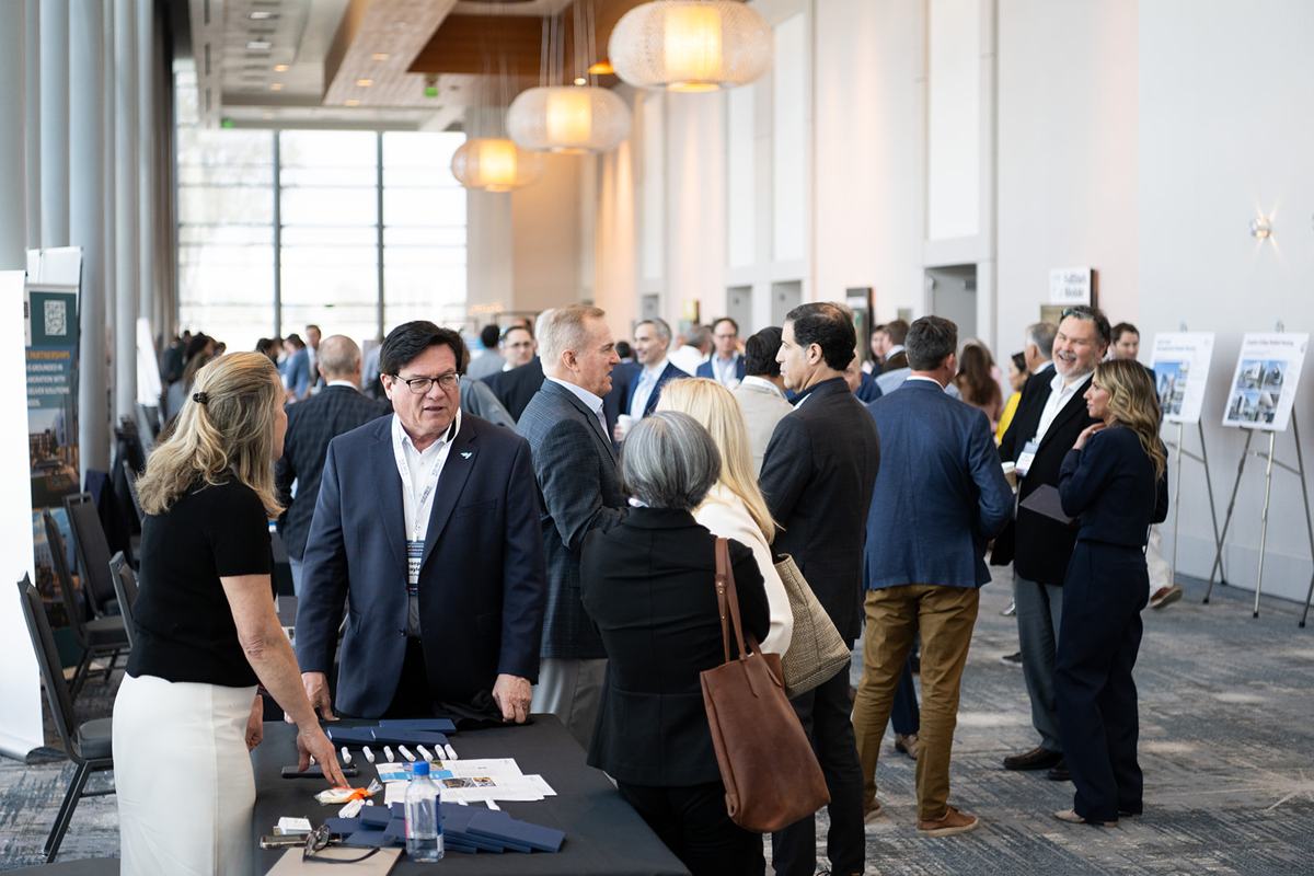 Attendees and exhibitors in a busy exhibit concourse