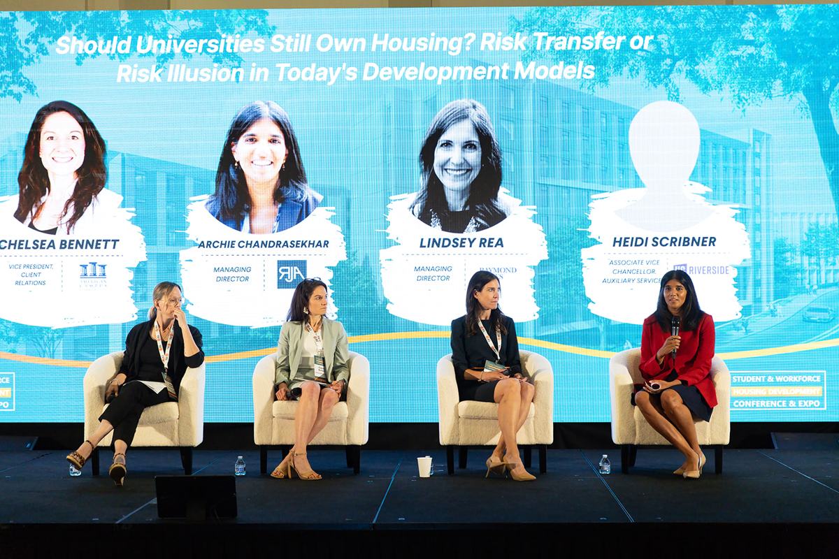 A panel on the main stage in front of a full audience at the 2025 Student & Workforce Housing Development Conference